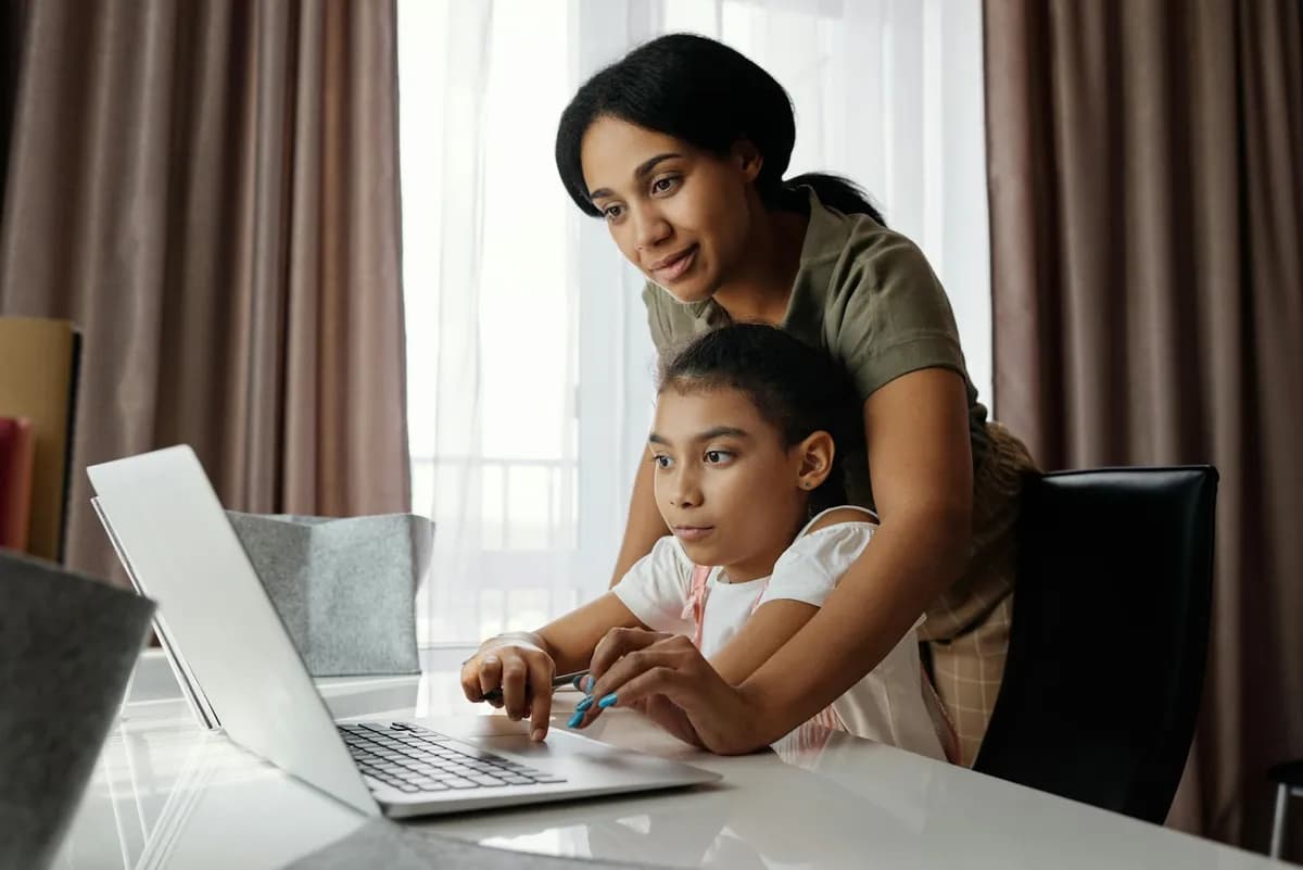 A mother helps her daughter with homeschooling mid-year